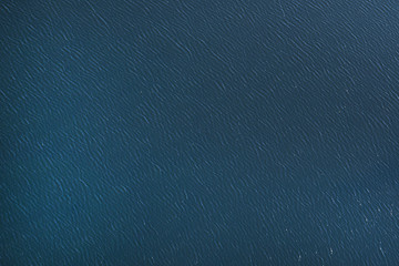 The surface of the blue sea, the lake. View from the plane