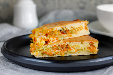 Pieces of pie with fresh young cabbage and carrots
