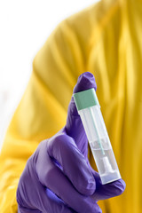 doctor with mask and safety suit, looking for information for vaccine.