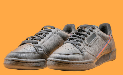 Black sneakers To wear for travelling Orange background or isolated
