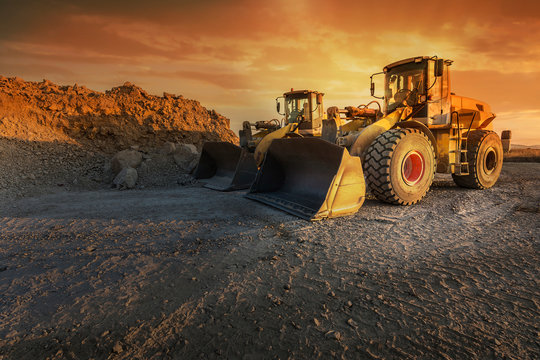 Two excavators moving stone and rock in a quarry