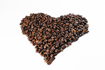 Coffee beans laid out on a white background with a basket