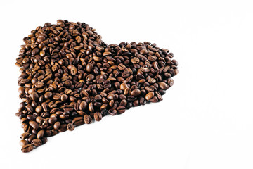 Coffee beans laid out on a white background with a basket