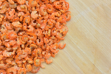 Dried shrimp in basket on wooden background. 