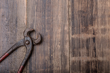 old pliers hand tool isolated on wood top view