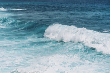 Naklejka na ściany i meble Large blue sea waves with white foam