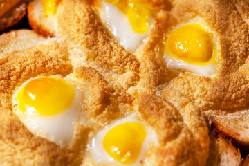 Breakfast, fried eggs with quail eggs with fried whipped whites on bread