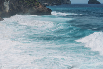 Large blue sea waves with white foam