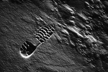 Footprint on black and white snow