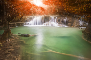 Waterfall in autumn forest with light ray  tyndall lighting effect ,Huay Mae Kamin Waterfall , Beautiful waterfall in rainforest at Kanchanaburi province, Thailand