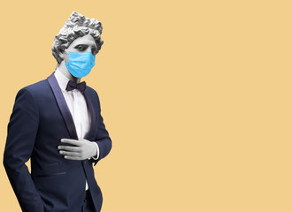Modern art collage. Concept portrait of handsome stylish man in elegant blue suit and medical mask .Gypsum head of of Apollo. Man in suit