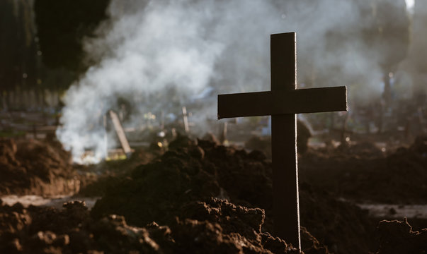 Cross, fire and death. After digging and removing the human rests of the graves, it seems a war landscape.