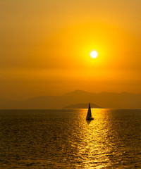 Obraz na płótnie Canvas Boat sailing in the Saronic Gulf near sunset