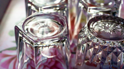Close up view of empty glass water on tray with natural sunlight.