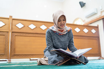 beautiful asian woman read quran in the mosque