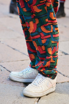 Man with white iridescent Nike shoes and colorful trousers on January 15, 2017 in Milan, Italy