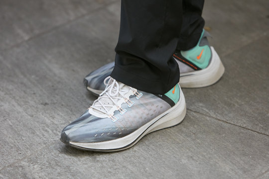 Man with Nike sneakers in gray and turquoise colors on June 15, 2019 in Milan, Italy