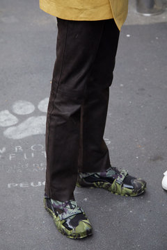 Man with green camouflage Nike shoes and black trousers on September 22, 2019 in Milan, Italy