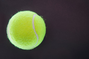 A tennis ball on the black background