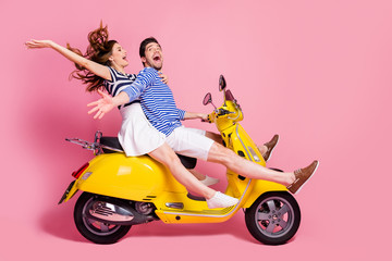 Fototapeta na wymiar Profile side view portrait of his he her she nice attractive cheerful cheery crazy carefree couple riding moped spending free time having fun fooling isolated on pink pastel color background