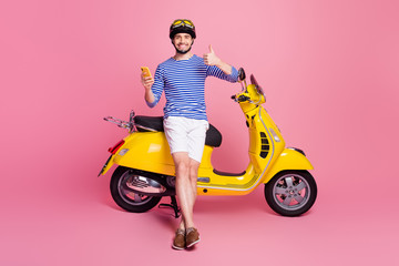 Fototapeta na wymiar Portrait of his he nice attractive handsome cheerful cheery guy sitting on moped using cell app 5g showing thumbup advert ad cool isolated over pink pastel color background