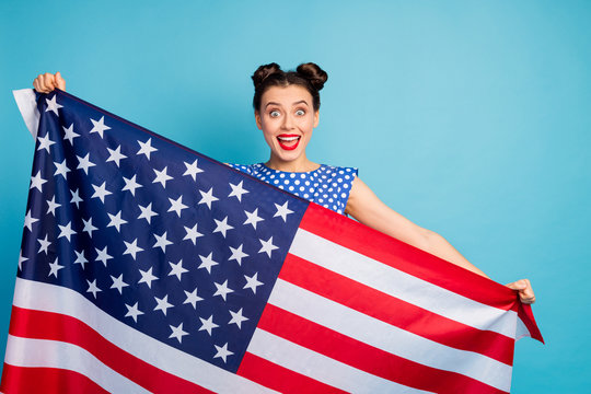 Photo of beautiful pretty lady open mouth holding big usa american flag celebrating national traditional holiday wear white dotted blouse shirt isolated blue color background
