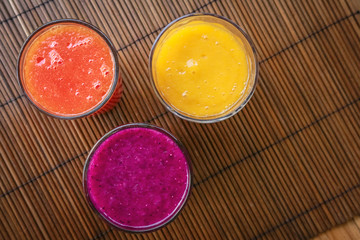 Dragon fruit, papaya and mango smoothies