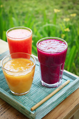 Dragon fruit, papaya and mango smoothies