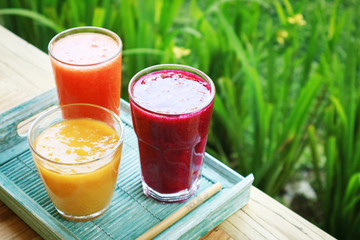 Dragon fruit, papaya and mango smoothies
