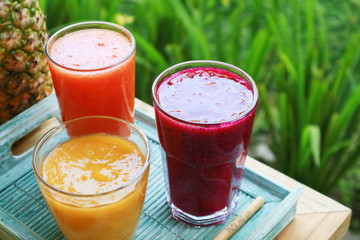 Dragon fruit, papaya and mango smoothies