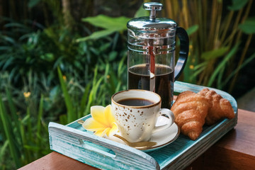 Cup of coffee with croissant