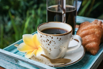Cup of coffee with croissant