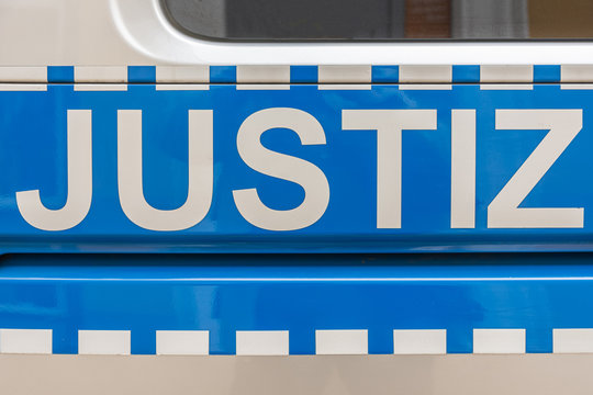 a police car in germany labeled with the word justice