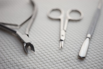 Set of tools for manicure on the white table closeup.