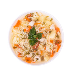 Plate of delicious chicken soup with noodles, isolated on white background, top view