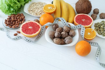 Various diet products on white wooden table with space for text