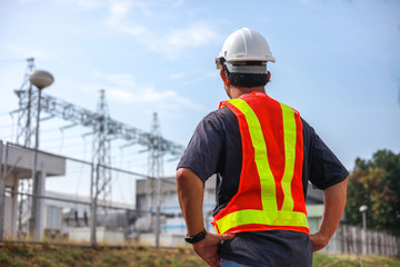 Engineering is checking progress on building construction of power plants,Young engineer standing at the substation.