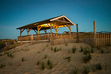Night lights still illuminate a pavilion before dawn at the Jersey shore