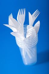 Fototapeta na wymiar single use plastic cups, forks, spoons. concept of recycling plastic, plastic waste