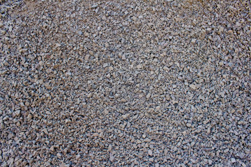 Stone crumb as creative textured background for your design, granite gravel backdrop with copyspace