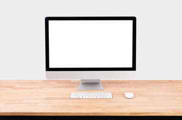 Mockup Blank screen desktop computer on wood table and white wall background.