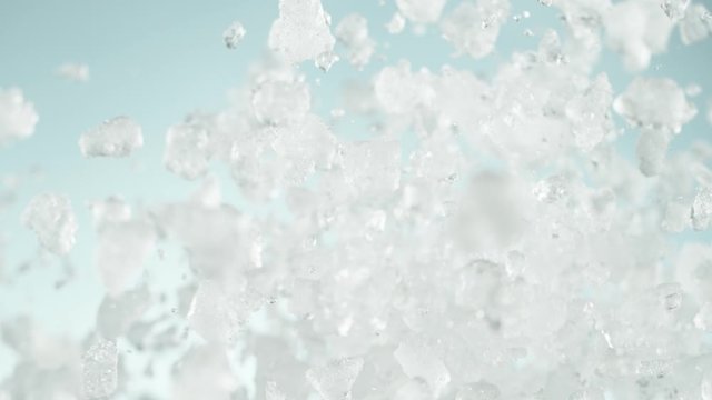 Super slow motion of falling crushed ice separated on white background. Filmed on high speed cinema camera, 1000 fps.