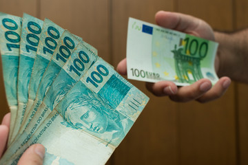 close on old real banknotes in hand, defocused euro background in hand
