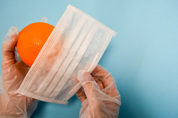 Citrus orange with vitamin C and a medical disposable protective mask for protection against...