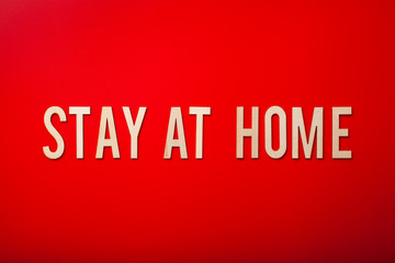 stay at home word text wooden letter on red background coronavirus covid-19