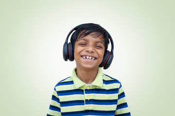 Boy with headphone while listing to music
