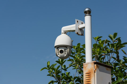 White surveillance camera in the park