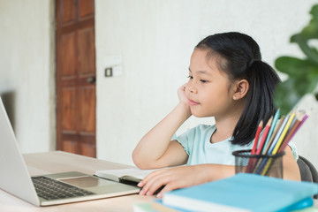 pretty  stylish schoolgirl studying homework during online lesson at home, social distance during quarantine, self-isolation, online education concept, home school, study online video call teacher.