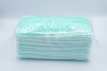 Coronavirus COVID-19 pandemic. antiviral medical mask for protection against corona virus. Surgical protective mask. Green face masks on white background. quarantine, social distancing, stay at home.