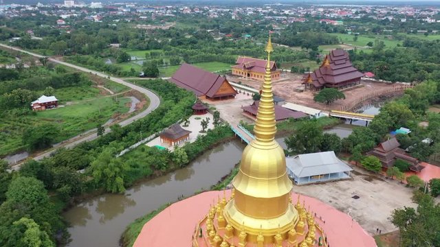 Aerial view of Wat Pa Wang Nam Yen. The biggest temple was mainly made of wood with 112 wooden pillars.  A new pagoda has been building in the area of the temple. Maha Sarakham province. Thailand.